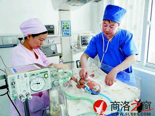 新生兒科的醫(yī)生與護士正在給患兒檢查身體