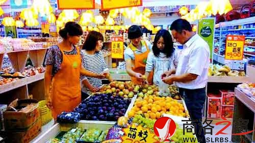 環(huán)境優(yōu)美的水果專賣店里，店員耐心地幫著顧客挑選水果。